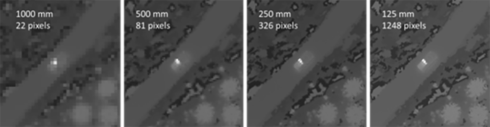 Infrared simulation of a landscape with vehicles, structures, and a distant aircraft.
